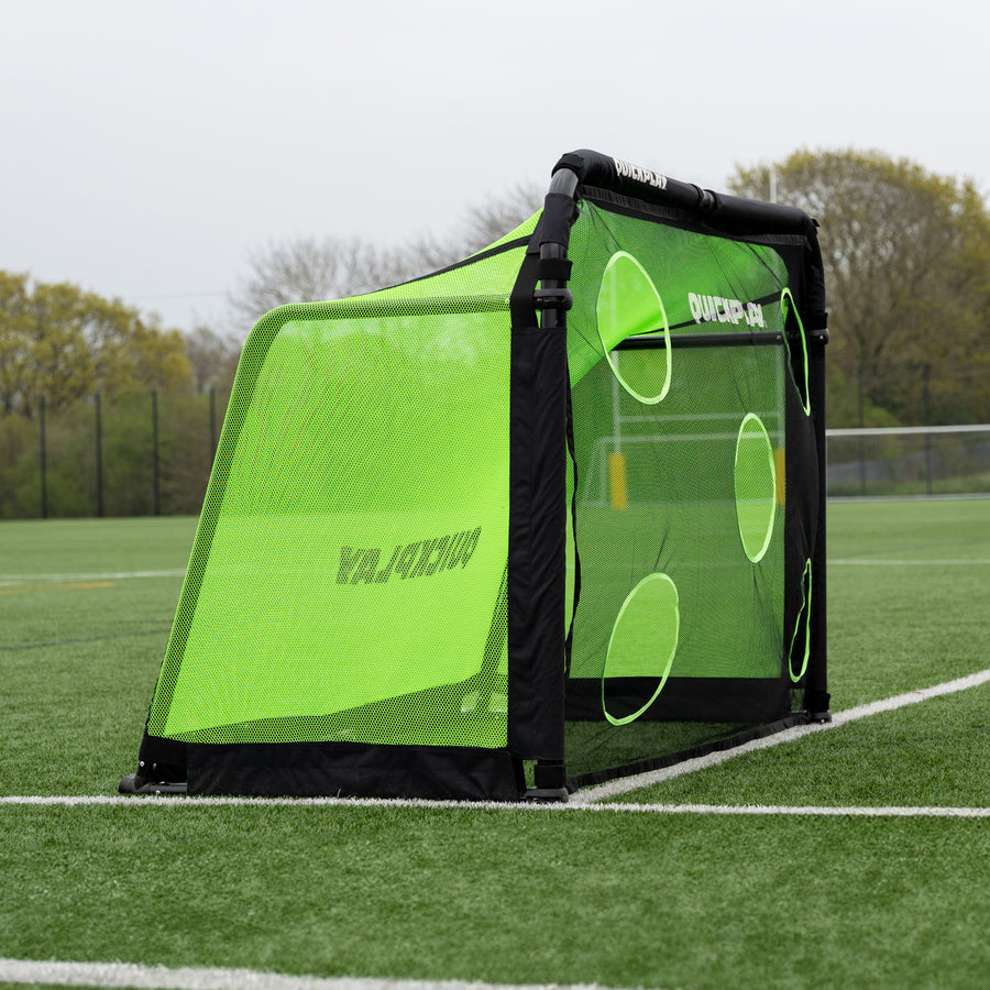 PRO ALU Training Target Net Lite 6x4' fitted to the front of a goal, seen from the side on an artificial pitch.