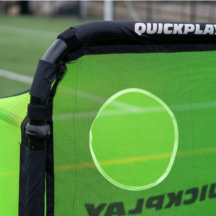 Close up of a top corner of the PRO ALU Training Target Net Lite 6x4', showing the black straps and a target hole.