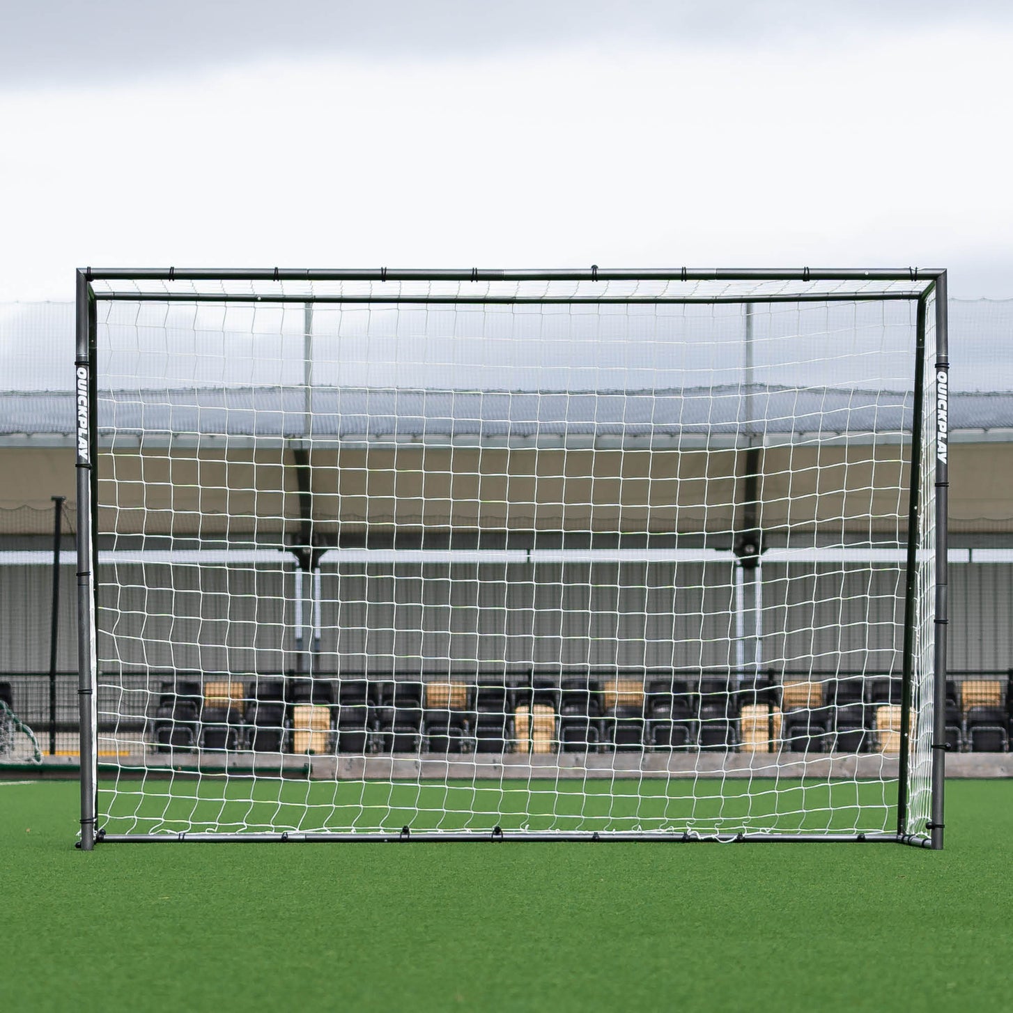 GS Series Futsal Goal 3x2m seen straight on in front of a covered stand on an artificial pitch.