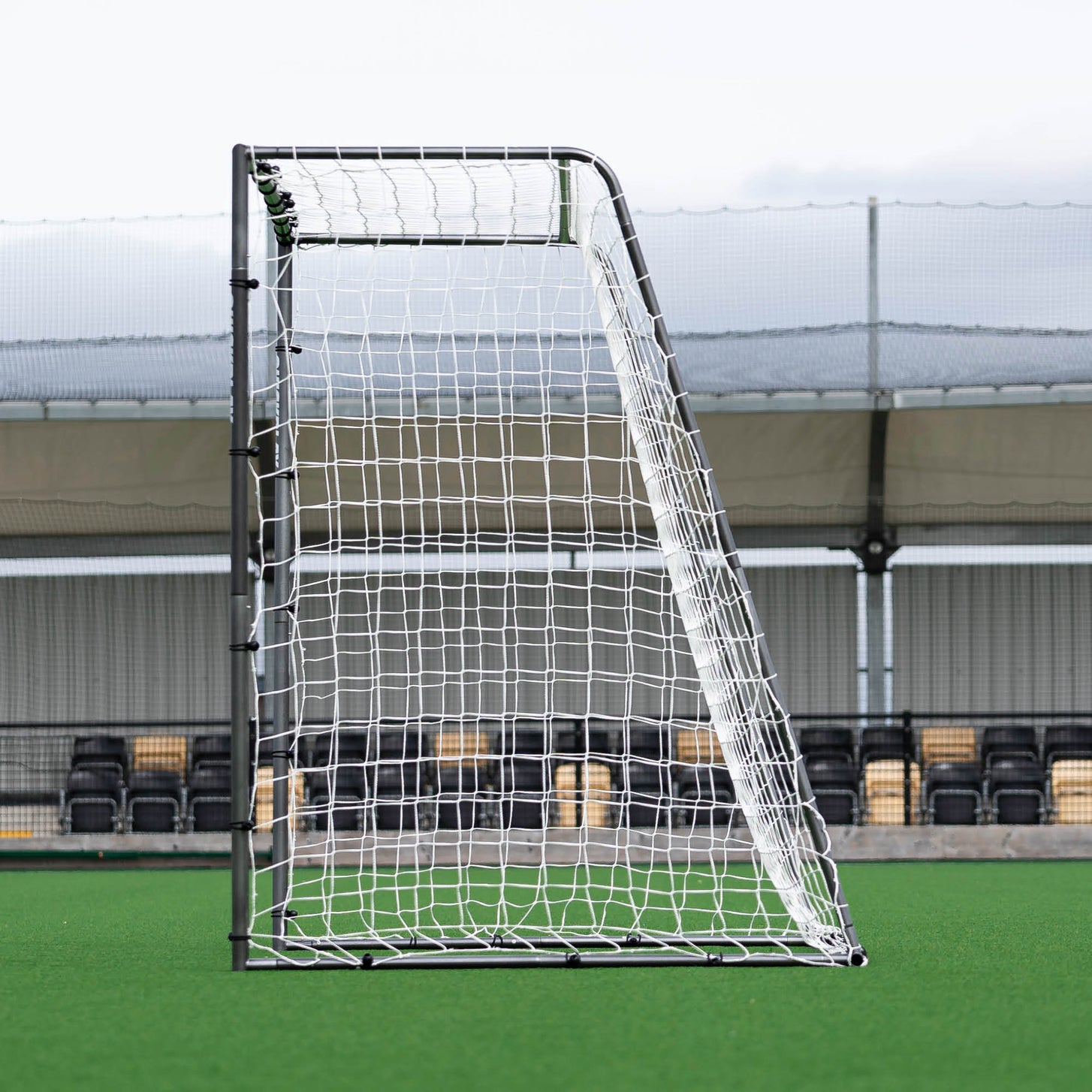 GS Series Futsal Goal 3x2m side view showing the black frame and the white net held out at the back.