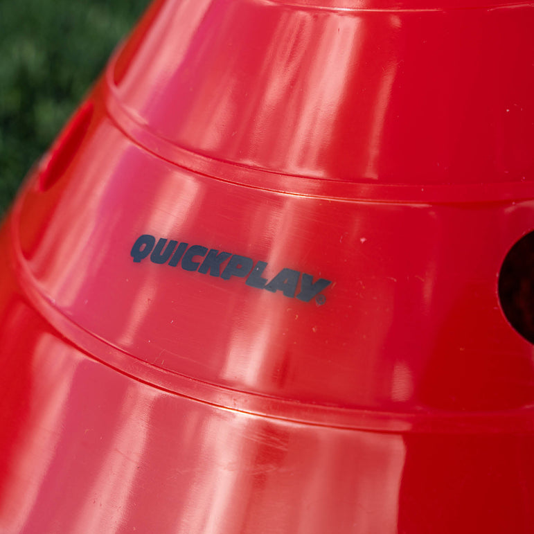 Red container with 'QUICKPLAY' branding on a blurred green background