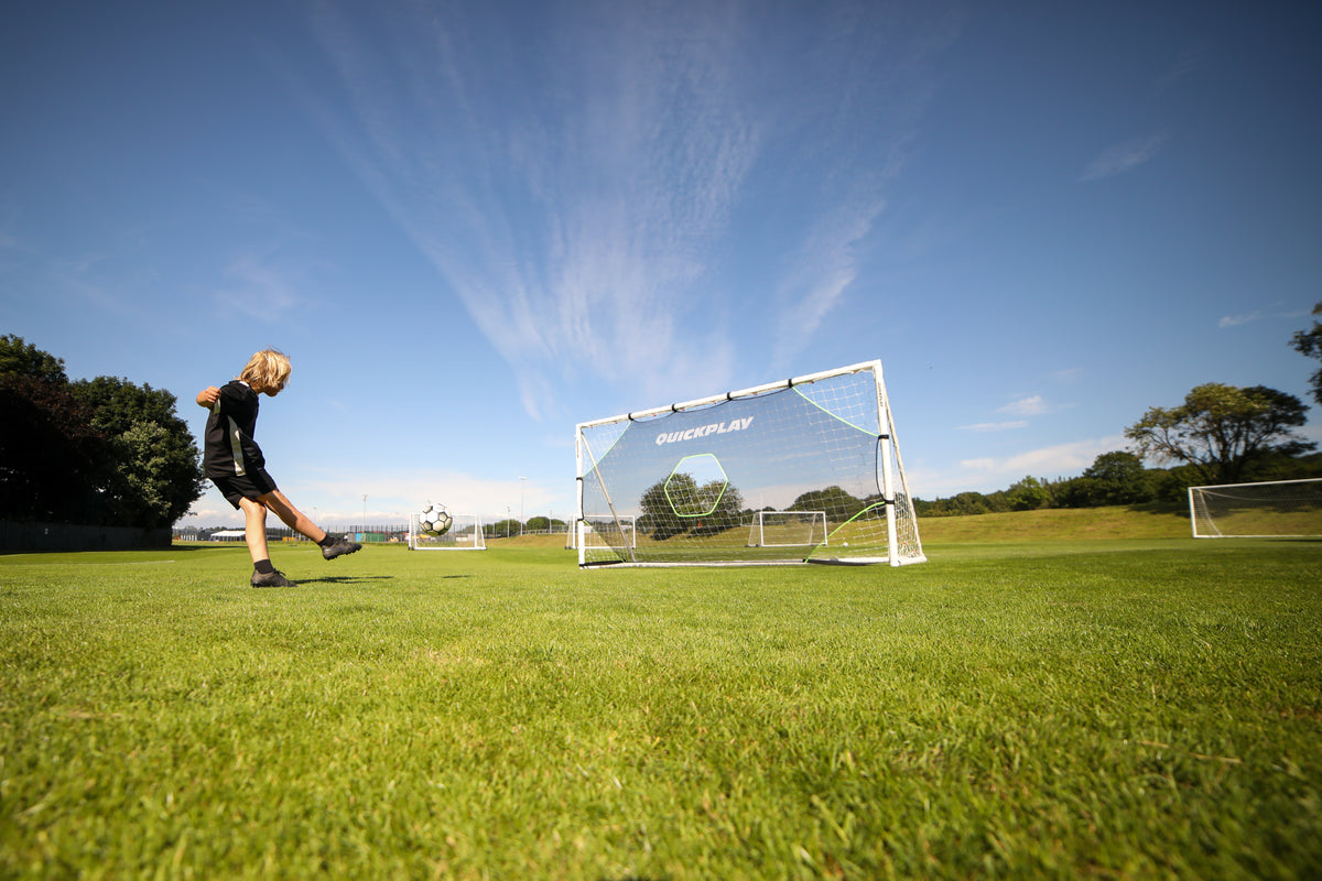 footballer shooting at a target net in a goal