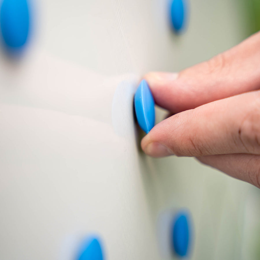 Magnetic Whiteboard (LG) 60x90cm close up: fingers placing a blue magnetic counter on the board.