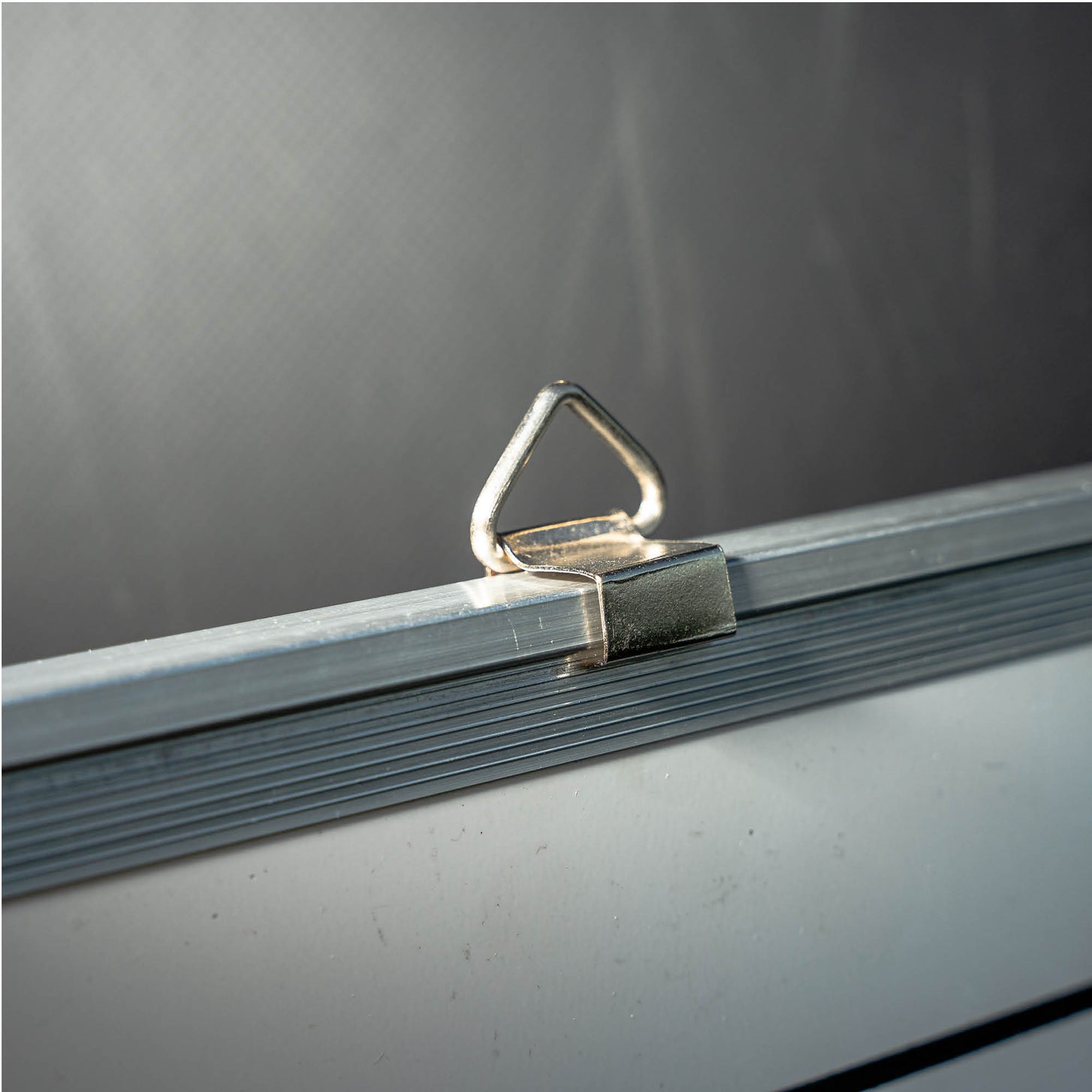 Magnetic Whiteboard (LG) 60x90cm close up of a metal hanging loop on the aluminium frame.