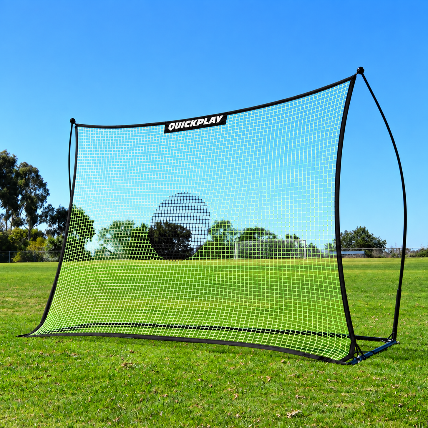 TEKKERS Net XL 8x6' football rebounder with a black frame and green net on grass, seen from the front at an angle.