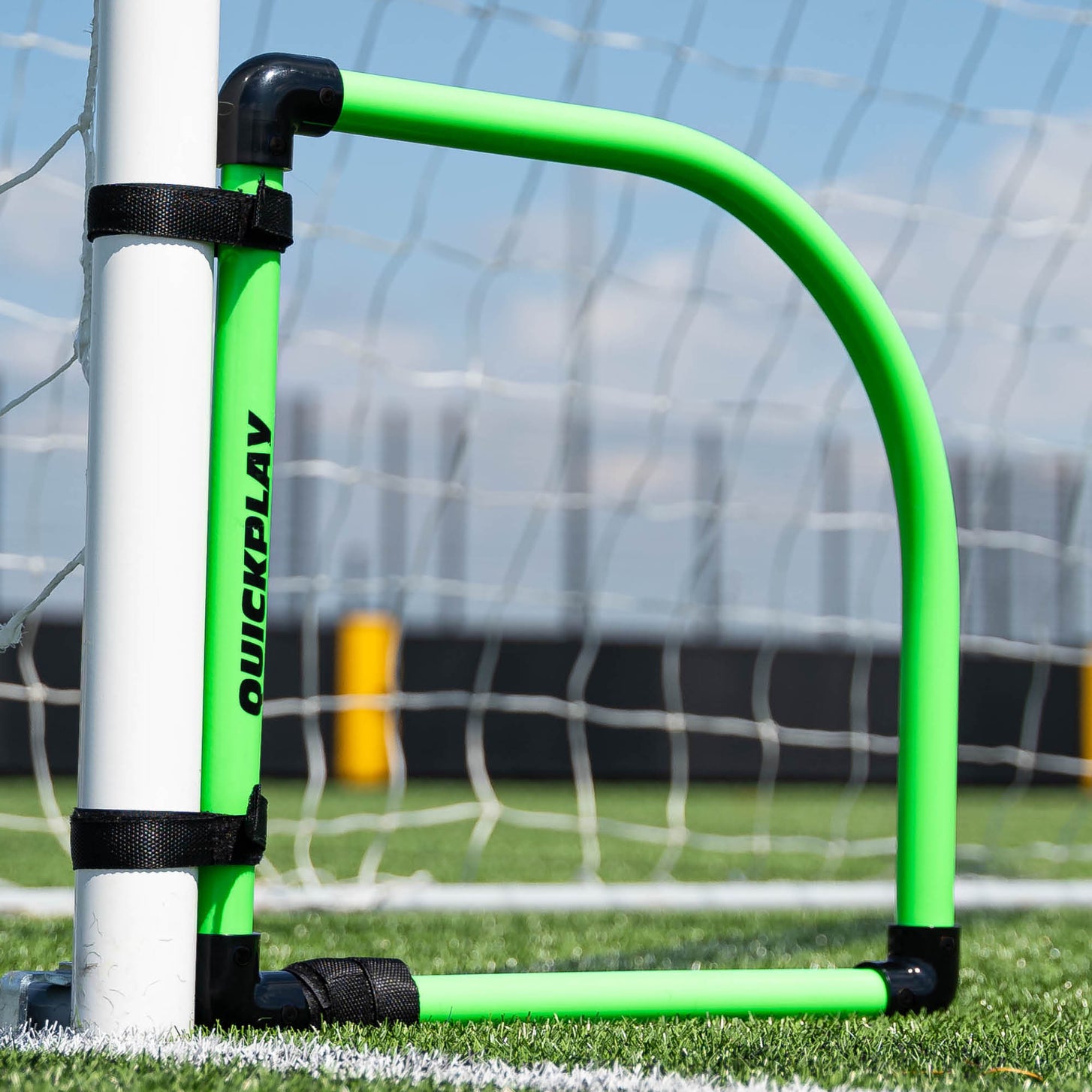 Goal Corner Target Frame strapped to the bottom corner of a goal on artificial grass.