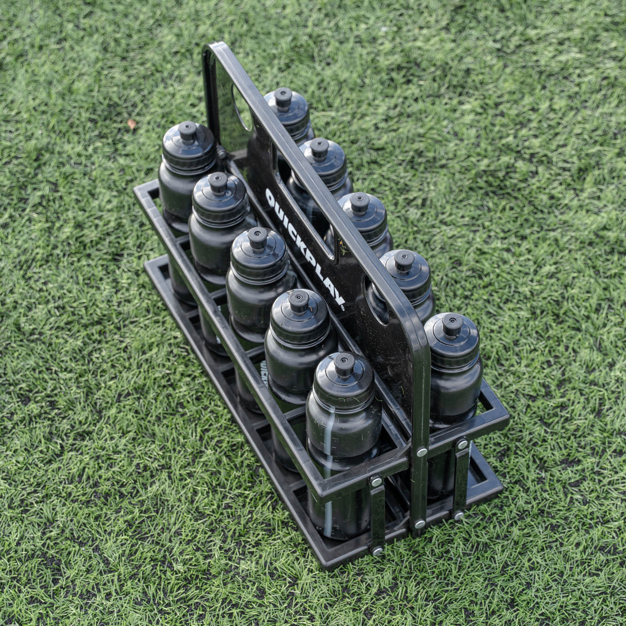 Black water bottle holder with bottles on a grassy background