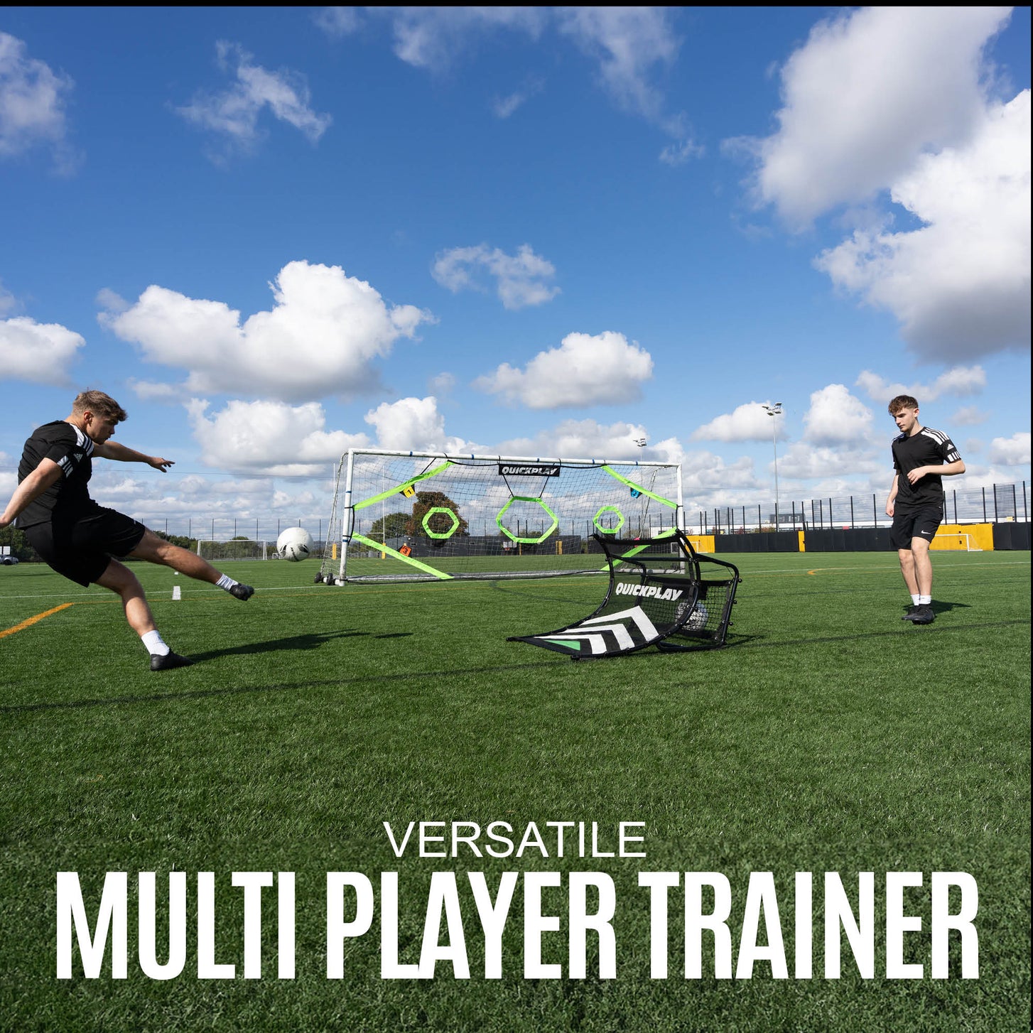 Two people playing with a football training device on a grass field with a clear sky.