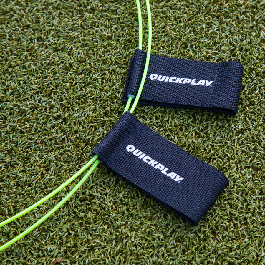 Two yellow-green KICKSTER Football Target Rings with black QUICKPLAY straps, close up on artificial grass.