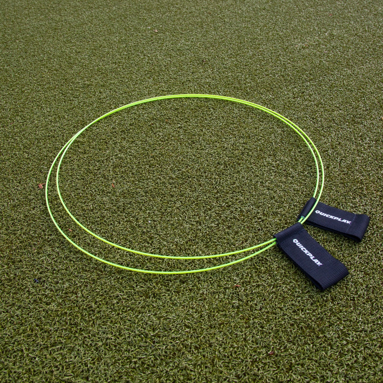 KICKSTER Football Target Rings (set of 2) laid flat on artificial grass, two yellow-green hoops with black straps.