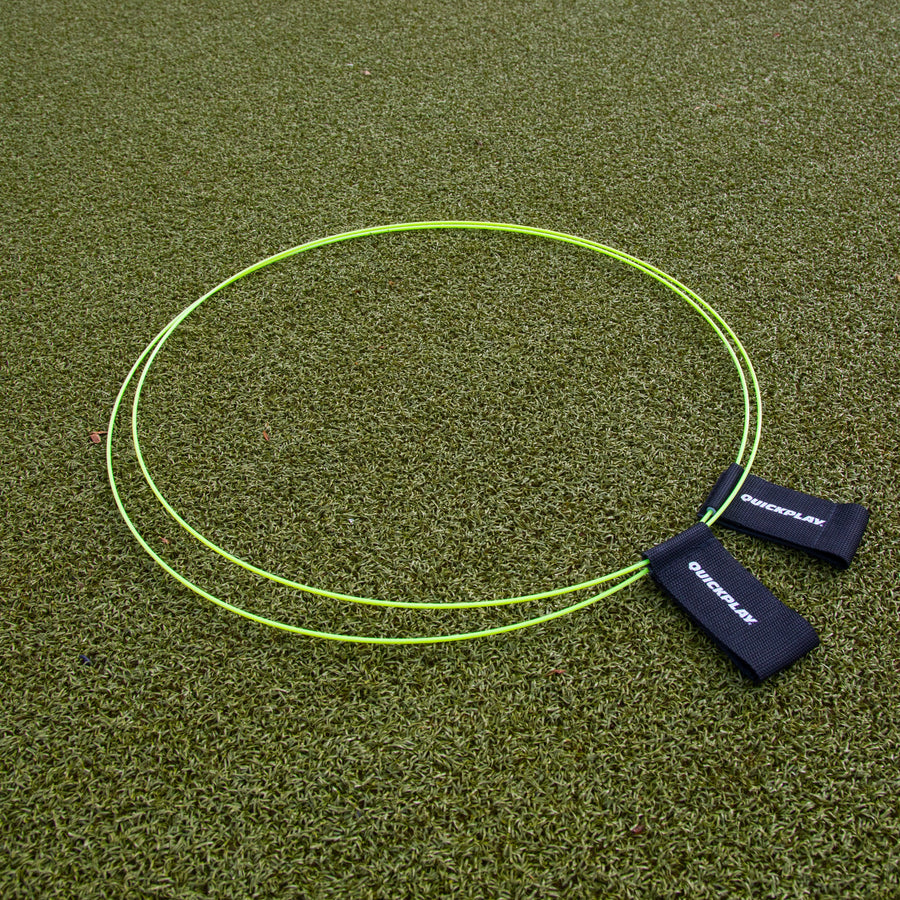 KICKSTER Football Target Rings (set of 2) laid flat on artificial grass, two yellow-green hoops with black straps.