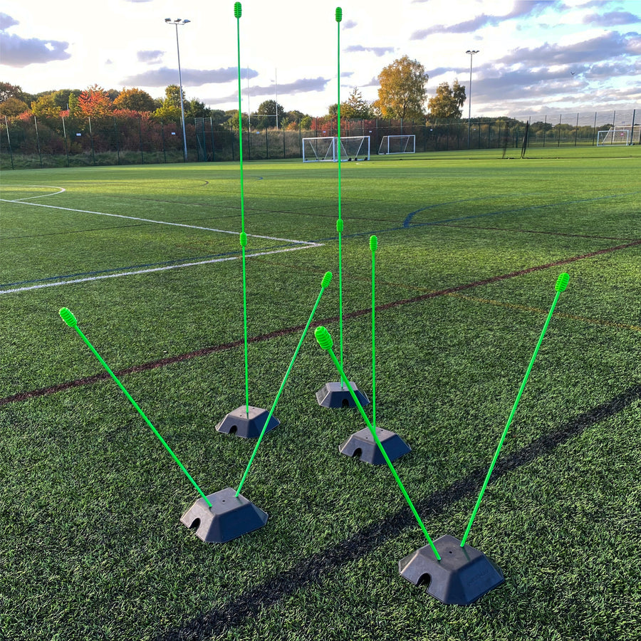 Green poles of different heights and angles set in black QUICKPLAY base weights on an artificial pitch.