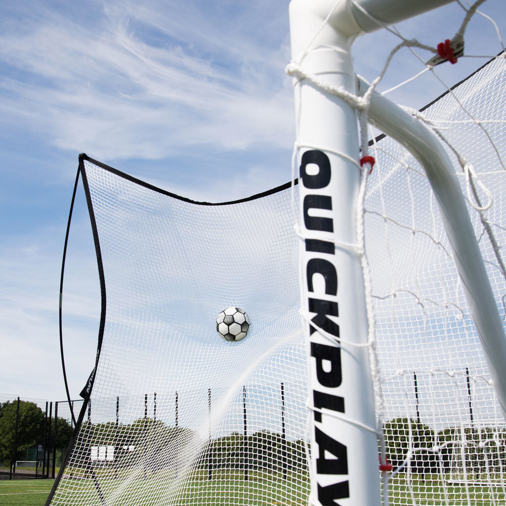 MEGA NET XL catching a football behind a white QUICKPLAY goal post, seen from inside the goal.