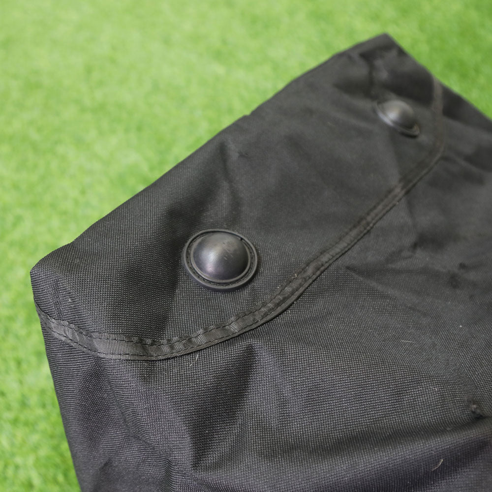 Close-up of a black press stud on the end flap of the Equipment & Goal Carry Bag (XXL).
