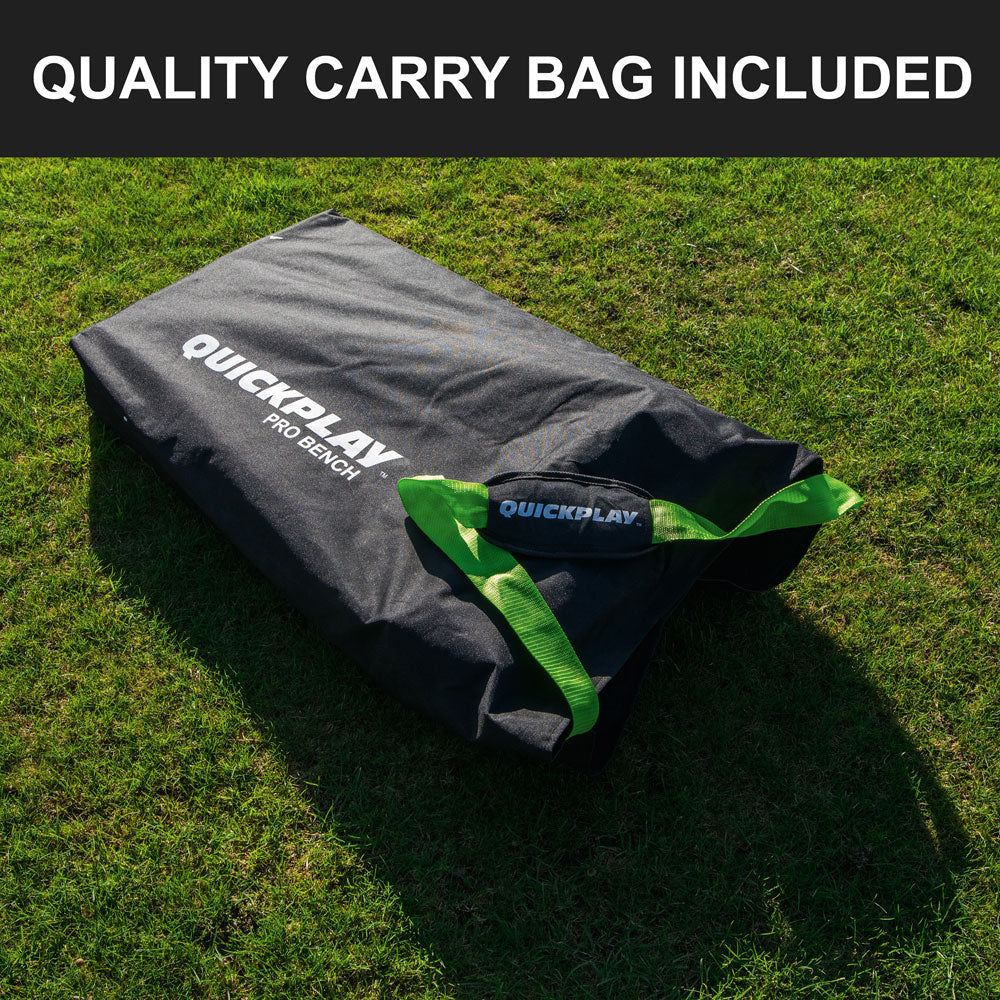 Black QUICKPLAY PRO Bench carry bag with green handles lying on grass, with the text "Quality carry bag included".